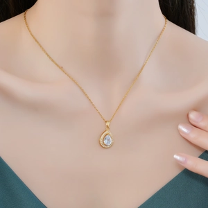 Elegant gold-plated waterdrop necklace with a clear pear-cut zircon on female model