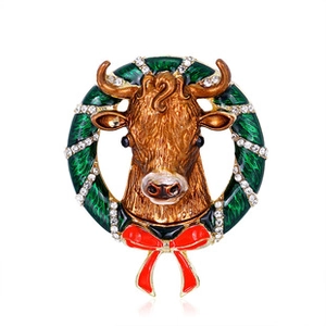 Detail of Christmas bull brooch with green enamel wreath, rhinestones and red bow tie