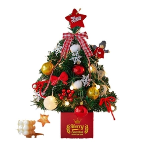 Mini lighted Christmas tree with ornaments and LED lights on a red base stand
