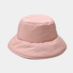Close-up of pink quilted down bucket hat showing thick padded fabric and stitch texture