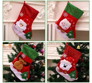 Detail of 3D Santa and Reindeer Christmas stockings hanging on a festive decorated tree