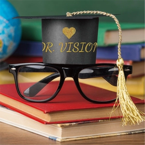 Mini graduation cap glasses on red books with gold glitter Dr. Vision lettering