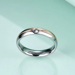 Detail of 4-6mm stainless steel ring with rose gold line and center set cubic zirconia