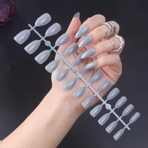 Detailed view of short oval glossy grey press-on nails set displayed on a model hand
