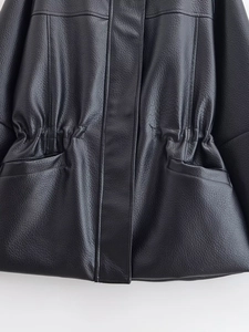 Detail of adjustable waist drawstring and side pockets on black leather jacket
