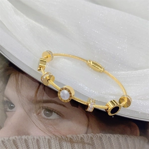 Elegant gold roman numeral bangle featuring mop inlay and sparkling crystal details