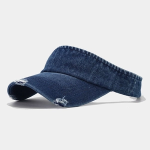 Detailed close-up of distressed denim sun visor with frayed edges and vintage texture