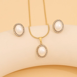 Detail of vintage gold jewelry set featuring oval pearls surrounded by crystals