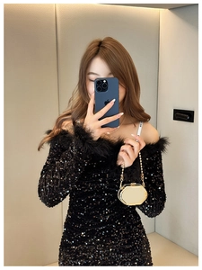 Detail of octagonal metallic chain bag paired with sequin dress and faux fur collar