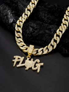 Close-up of golden iced-out Cuban chain with crystal encrusted PLUG pendant for men