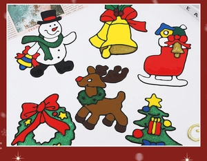 Macro detail of Christmas stickers with glitter finish featuring reindeer and tree