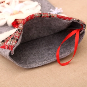 Detail view of large Christmas stocking with red plaid cuff and silk hanging loop