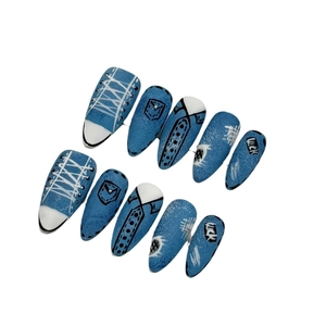 Hand-painted denim style press-on nails featuring canvas shoe lace and lucky patch designs