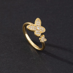 Detailed close-up of golden open butterfly ring with shimmering white cubic zirconia