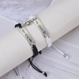 Close-up of His Queen and Her King magnetic heart charms on braided couple bracelets