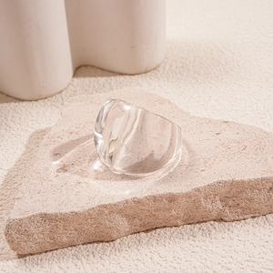 Macro shot of transparent resin square ring on a stone base showcasing thick modern design