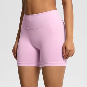 Detail showing high-waisted ribbed waistband on seamless pink yoga shorts for women