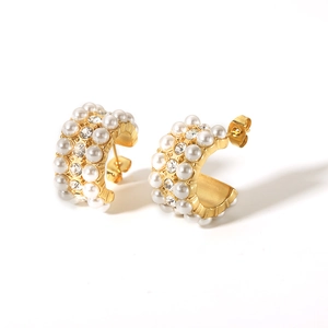 Detail of 18K gold plated C-hoop earrings with white pearls and clear rhinestones