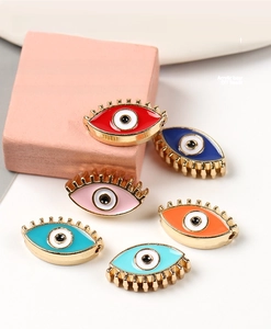 Macro detail of colorful enamel evil eye charms with side holes for DIY jewelry