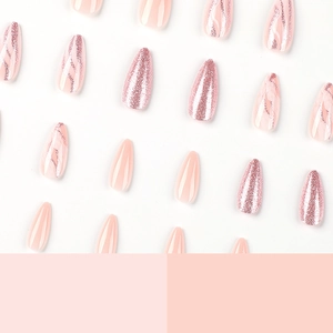 Press-on nails in soft pink, glitter and marble design with long almond shape