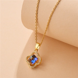 Golden 18k clover necklace with blue crystal pendant and sparkling stones