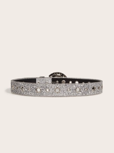 Close-up of silver sequin belt featuring metallic eyelets and a classic buckle design