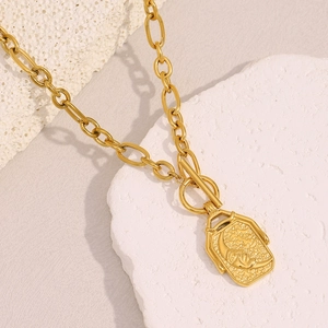 Detail of 18K gold-plated necklace featuring a portrait relief pendant and T-bar toggle clasp