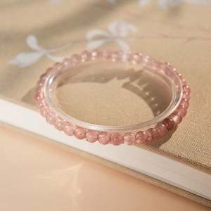 Macro detail of strawberry quartz beaded bracelet with natural pink crystal textures