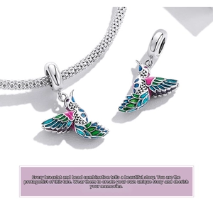 Detailed macro view of S925 silver hummingbird charm with colorful enamel on a bracelet