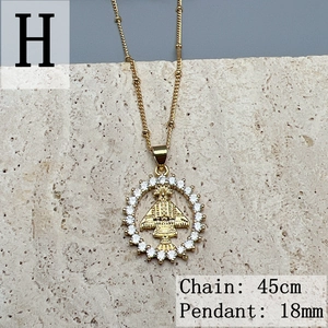 Macro shot of 18mm golden Virgin Mary pendant with sparkling white cubic zirconia stones