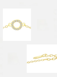 Macro detail of S925 sterling silver gold bracelet with zircon pendant and hallmark