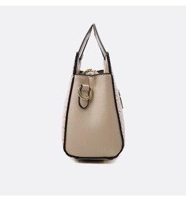 Detailed macro view of beige faux crocodile leather texture and gold hardware on handbag