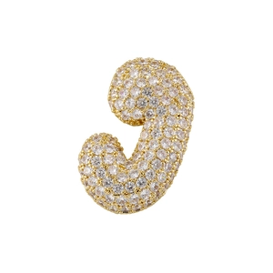 Macro detail of gold-plated puffy letter J pendant paved with sparkling zircon stones