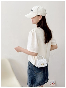 Fashionable white PVC jelly bag styled with a pearl handle for women's crossbody wear