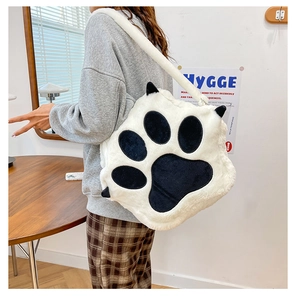 Detail of soft white plush cat paw crossbody bag featuring a fluffy faux fur texture