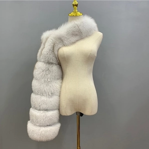 Close-up detail of plush light gray faux fox fur shawl with segmented textures