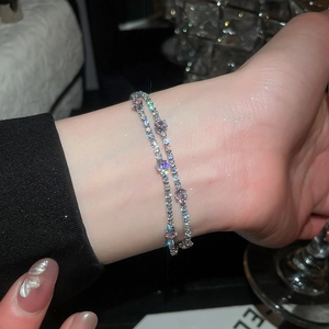Sparkling double-layered zircon bracelet with 18k gold plating shown on wrist.