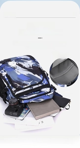 Detail view of the large capacity interior compartments of the blue camo school backpack