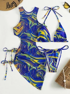 Flat lay of 3-piece bikini set with marble print, mesh cover-up, and beach accessories