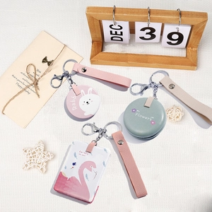 Close-up of three decorative PU leather keychain mirrors in rabbit and floral designs
