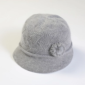 Detailed top view of a grey knit bucket hat with decorative flower and plush texture