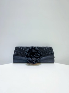 Black pleated evening clutch bag with elegant fabric rose flower detail for formal banquet events.