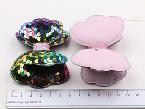 Detail of colorful sequin bow hair clip showing front texture and 8.5cm measurement