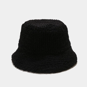 Close-up of black fuzzy faux shearling texture on thick winter bucket hat