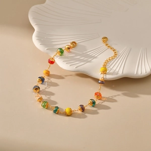 Colorful beaded bracelet with 18K gold plated chain and lobster clasp closure in warm light