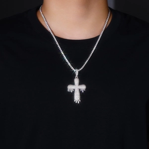 Detailed view of silver iced-out drip cross pendant with shimmering moissanite stones
