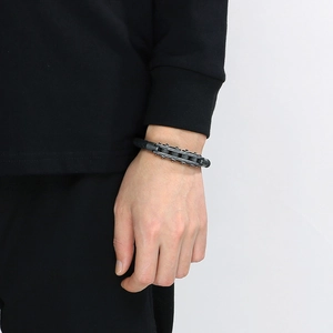 Macro shot of men's industrial watch band bracelet with woven black leather details