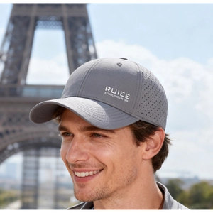 Detail of grey quick-dry baseball cap with laser-cut ventilation holes and RUIEE logo