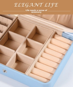 Detail of light blue jewelry box with velvet ring slots and storage compartments