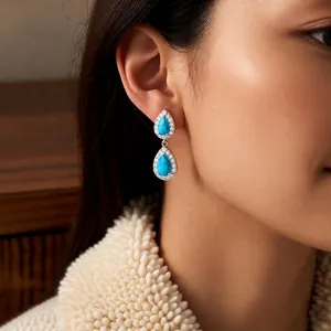 Vintage silver needle drop earrings with turquoise stones on model side view